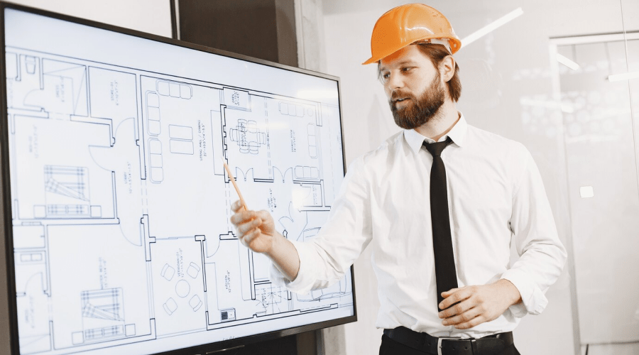 architect-engineer-man-shows-plan-building-tv-screen_1157-48543 1